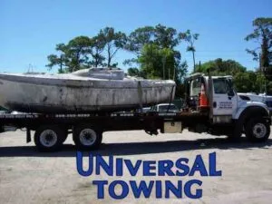 Boat that needs a tow in transit to the dump